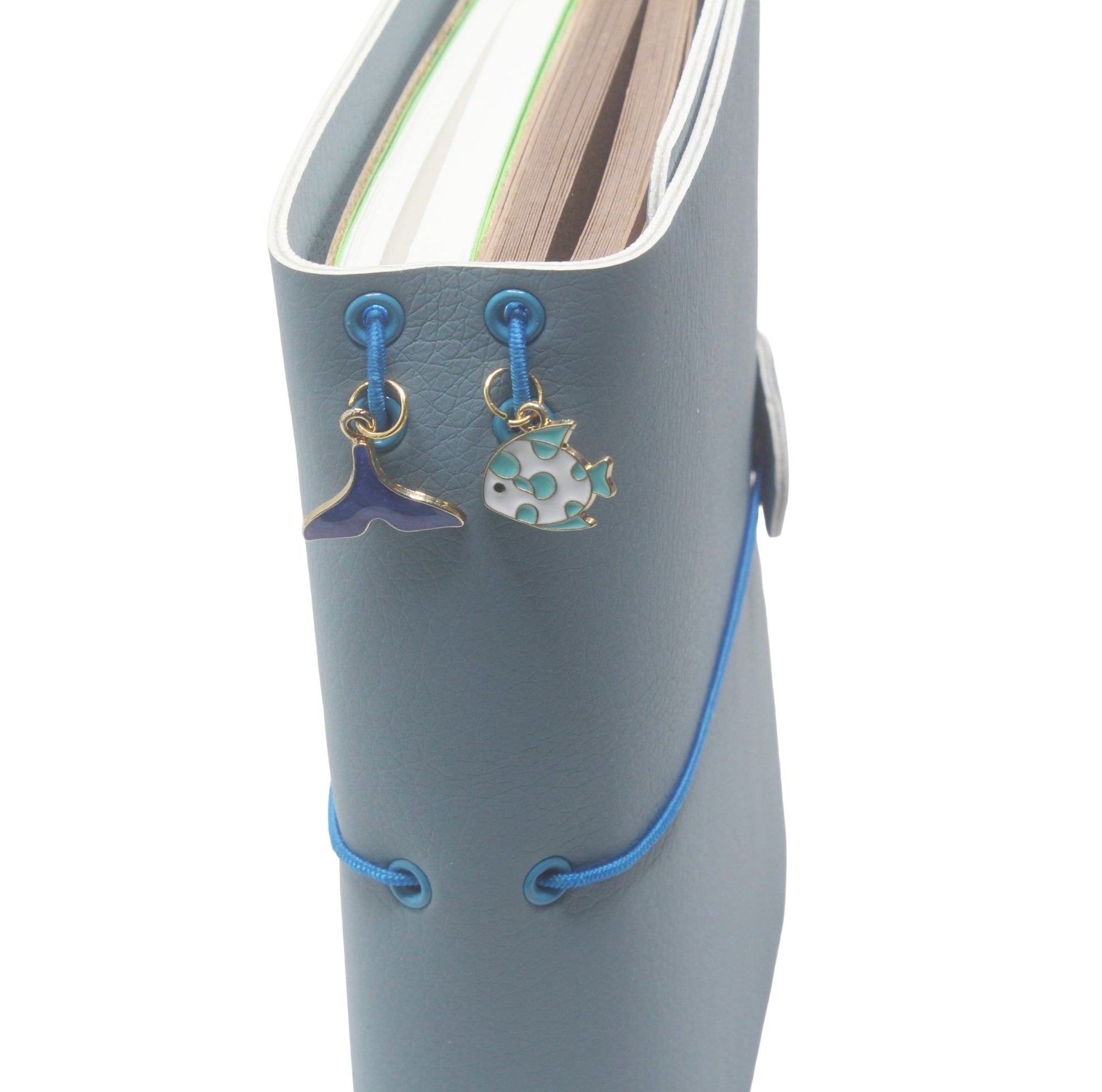 Blue book with blue laces and charms on a white background